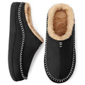 Pair of black slip-on slippers with tan fuzzy lining and white stitched trim.