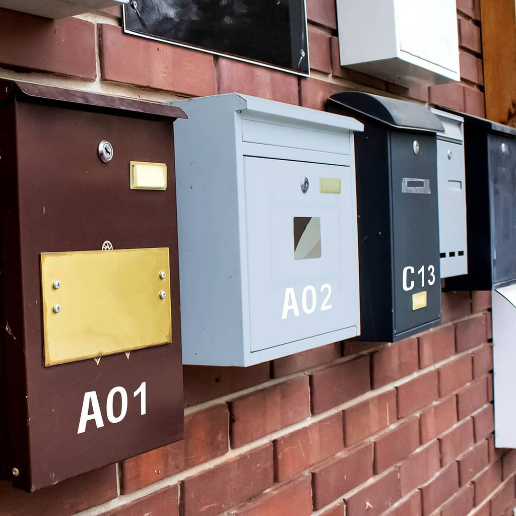 White vinyl mailbox letters and numbers on multiple mailboxes, labeled A01, A02, C13
