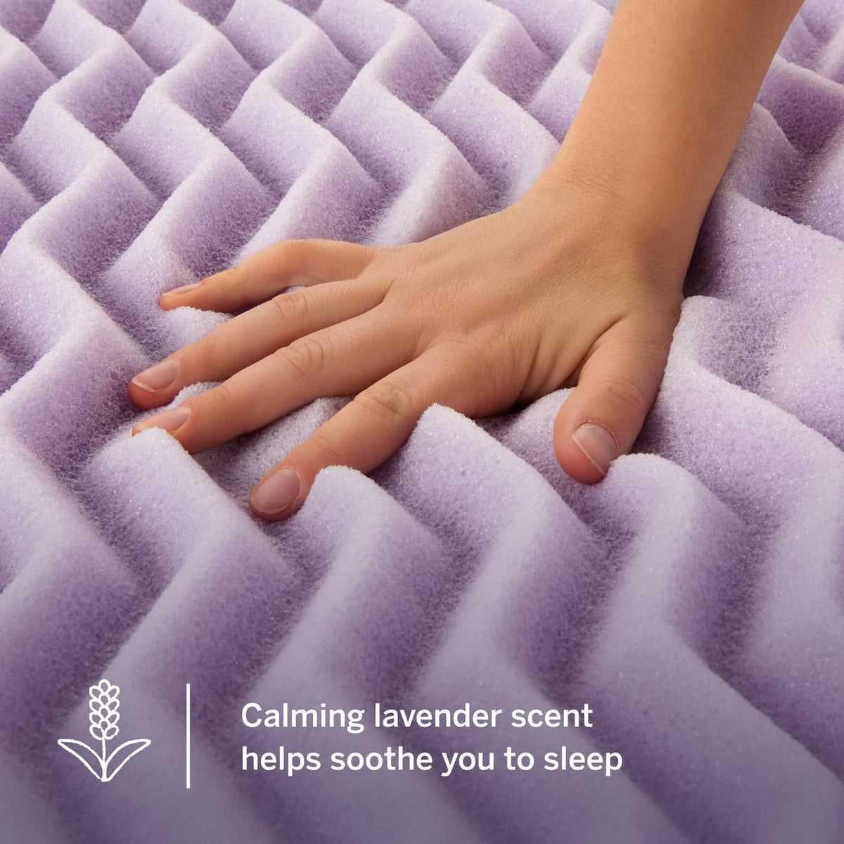 Lavender memory foam topper close-up with hand resting on textured ridges