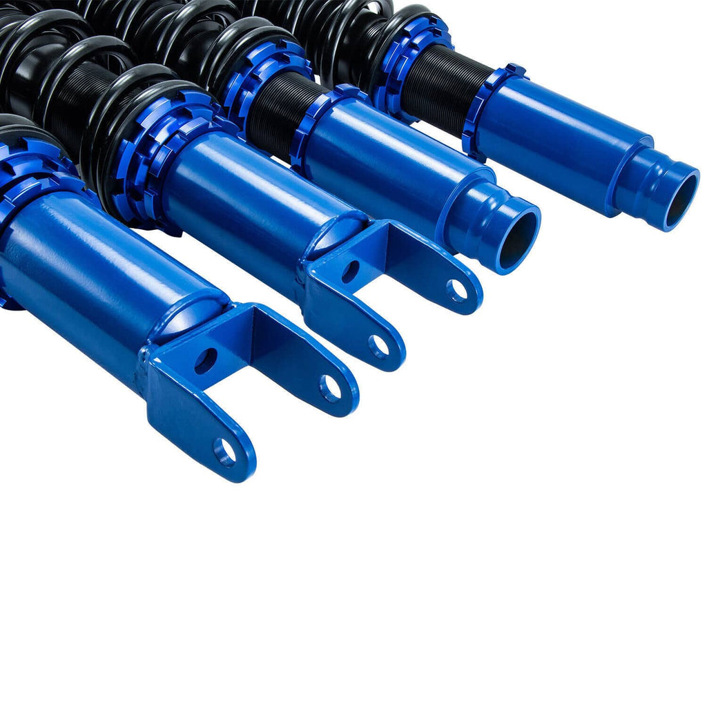 Close-up of blue coilover shock bodies with black springs and mounting brackets