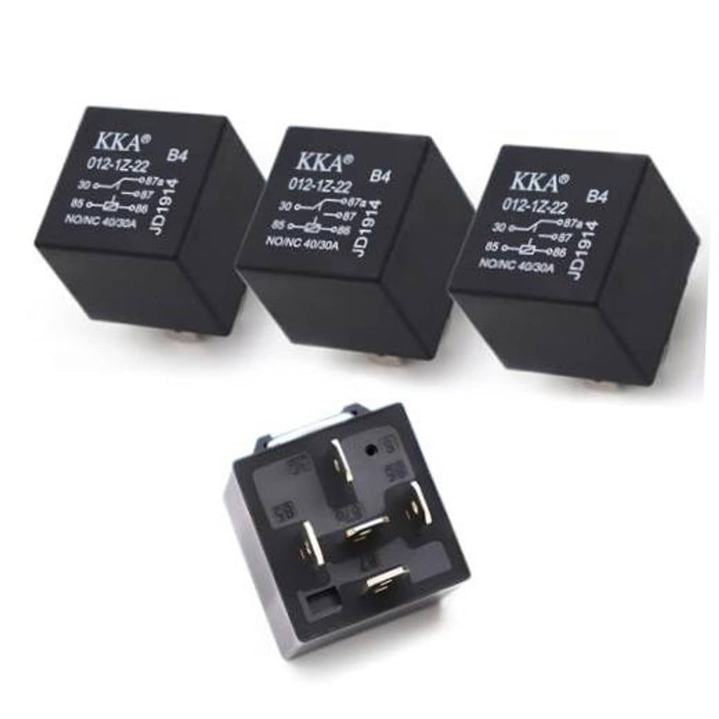 Set of three black automotive relays with printed labels and open 5-pin socket
