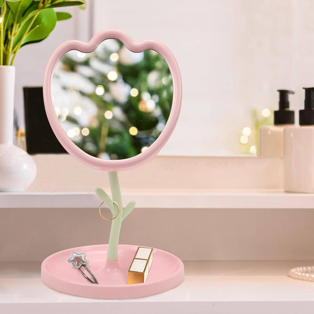 Pink flower-shaped vanity mirror with round stand base and reflective glass