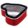 Red pleated motorcycle air filter with black foam outer frame, triangular shape