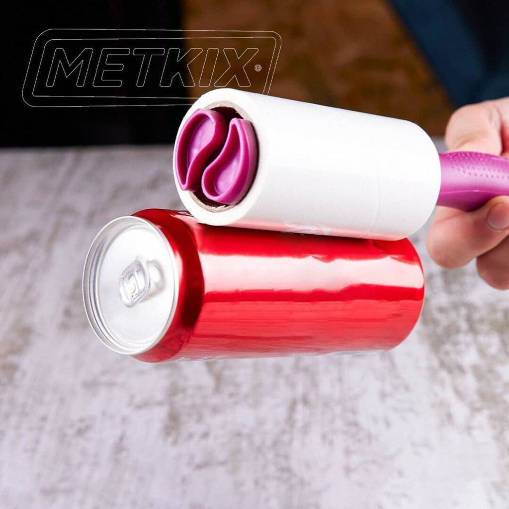 Close-up of pink and white Metkix lint roller refill rolls being held