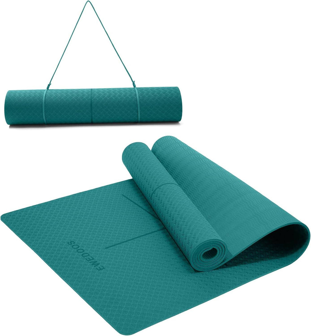 Teal yoga mat with alignment lines and textured grip surface, laid flat