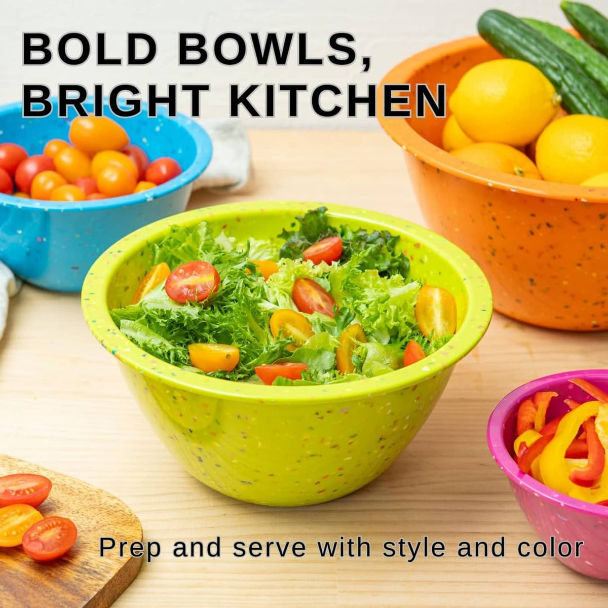Green confetti-speckled mixing bowl with salad, plus orange and blue bowls nearby