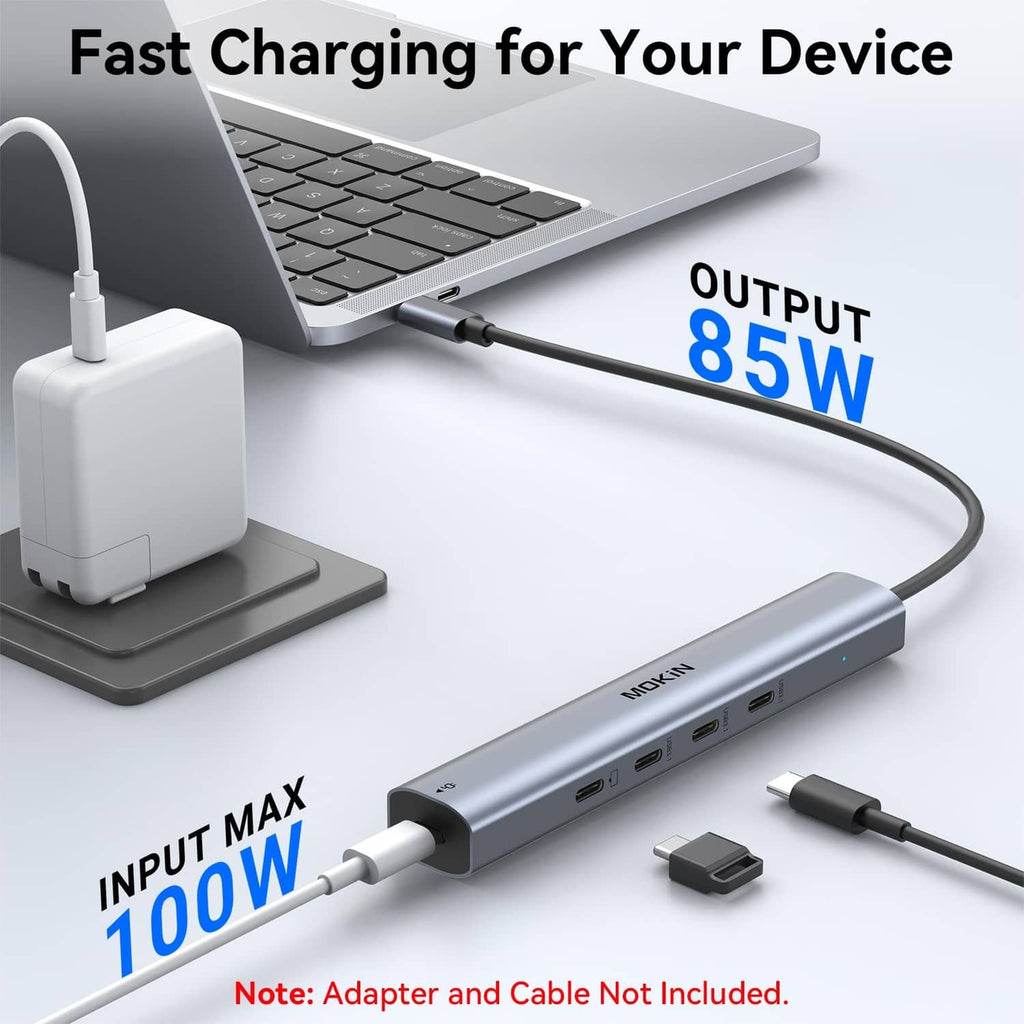 USB-C hub with charging cable connected to a laptop and power adapter