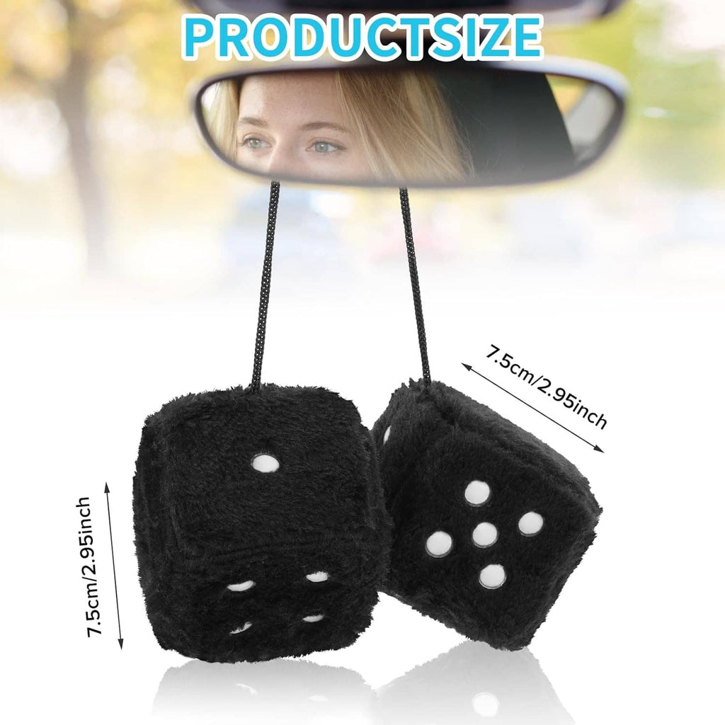 Pair of black fuzzy dice with white dots hanging by two strings from mirror
