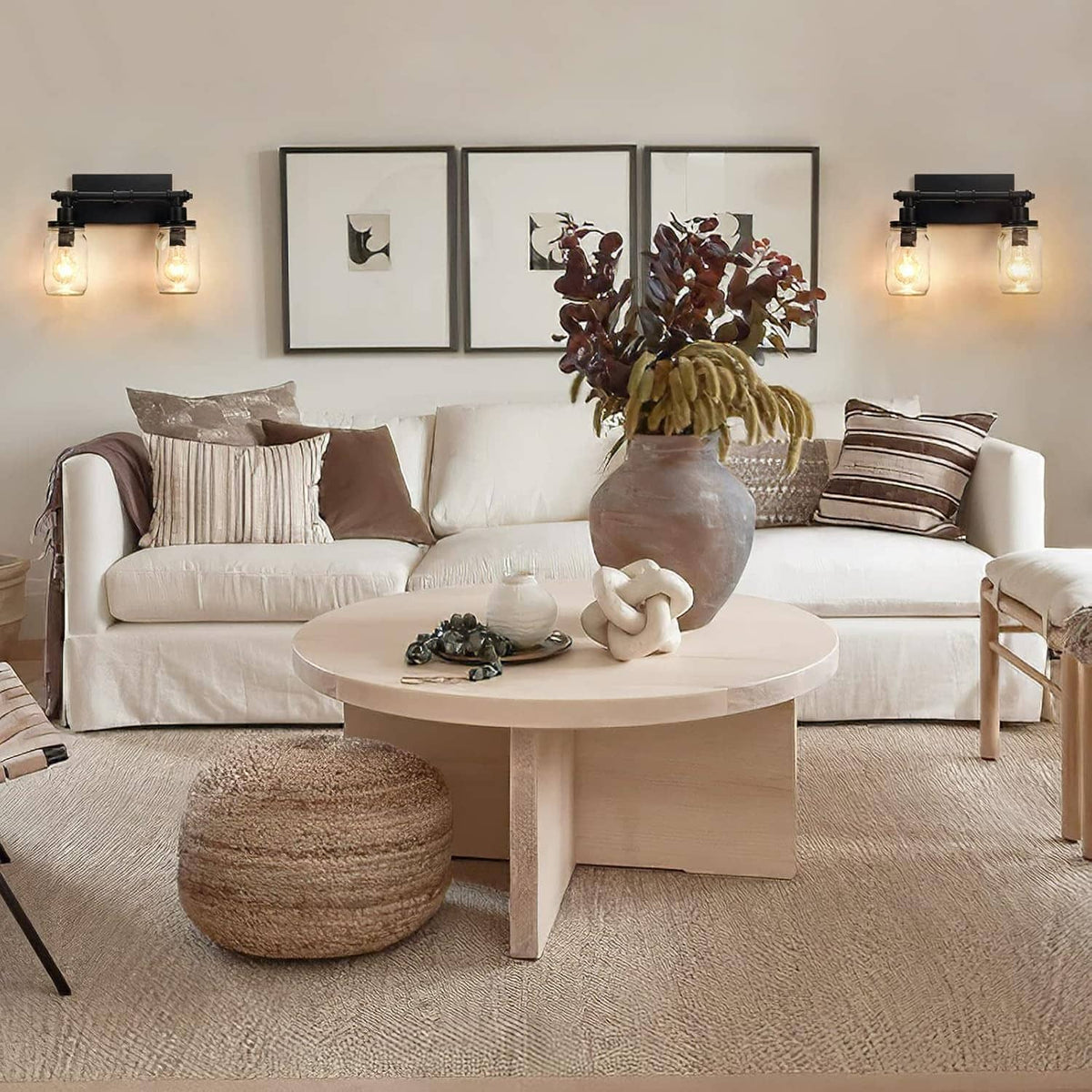 Black 2-light wall vanity light with two clear mason-jar shades glowing softly
