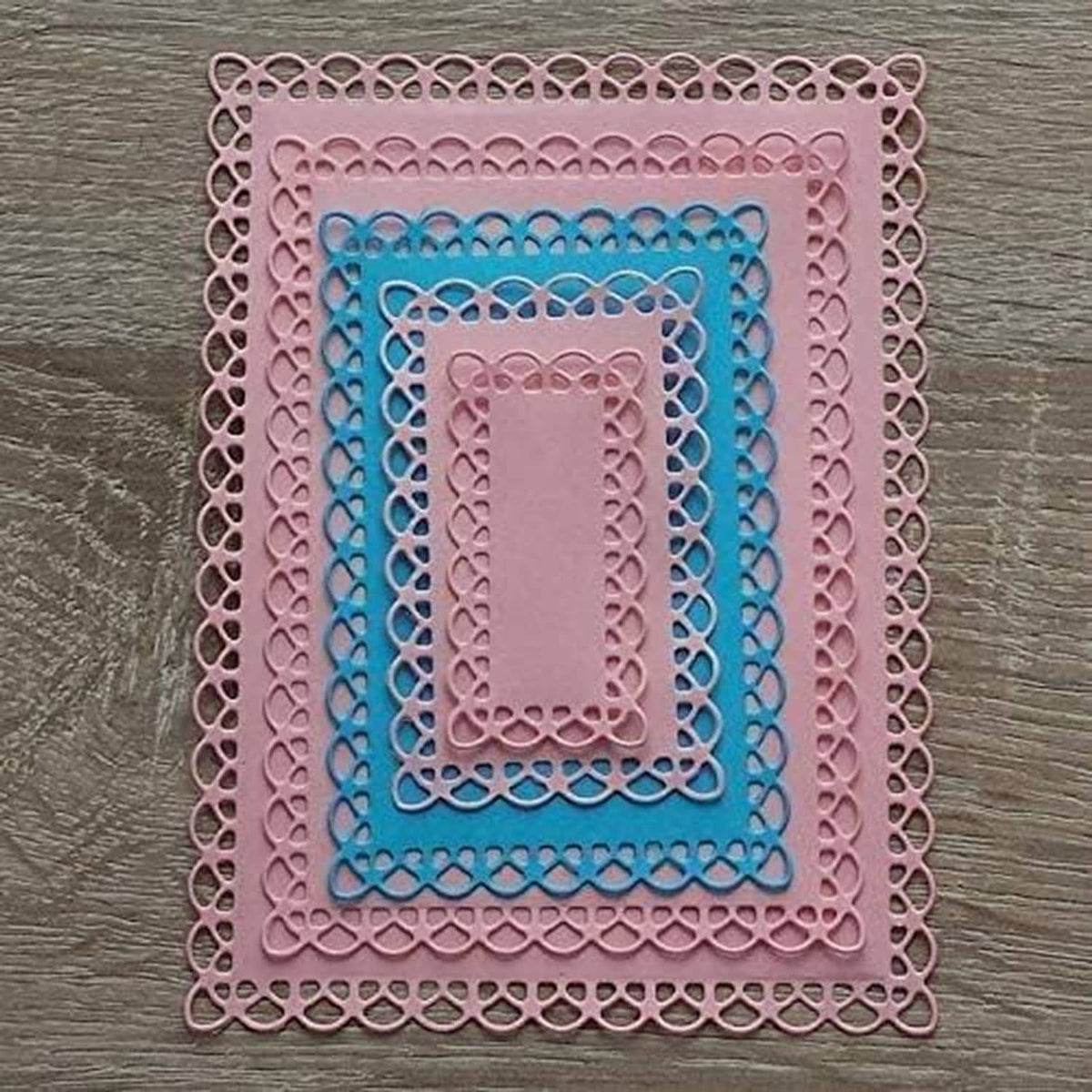 Stacked scalloped rectangle frame dies in pink and blue on layered cut shapes