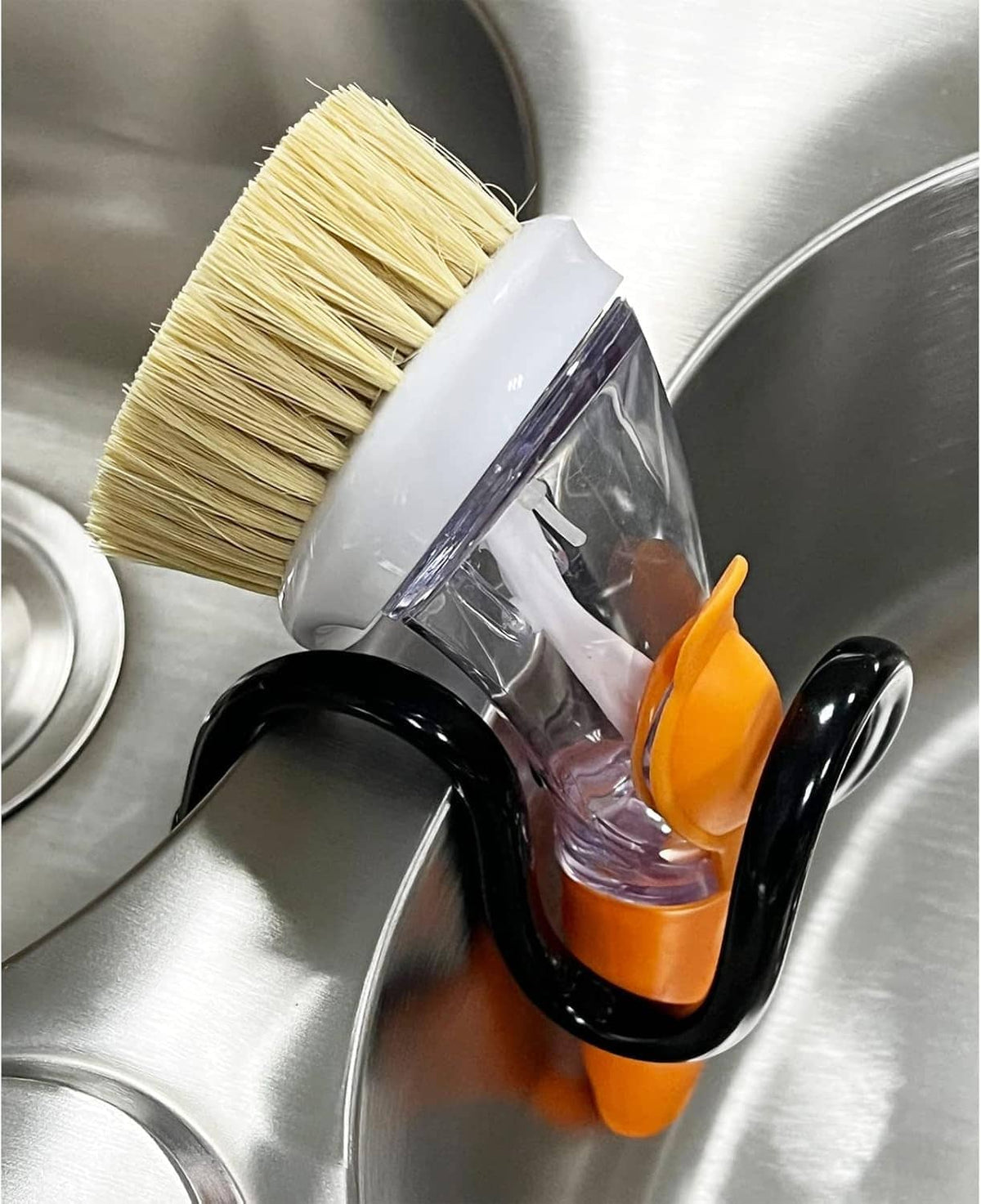Adjustable dish wand holder with dish brush and orange/black clips on stainless sink