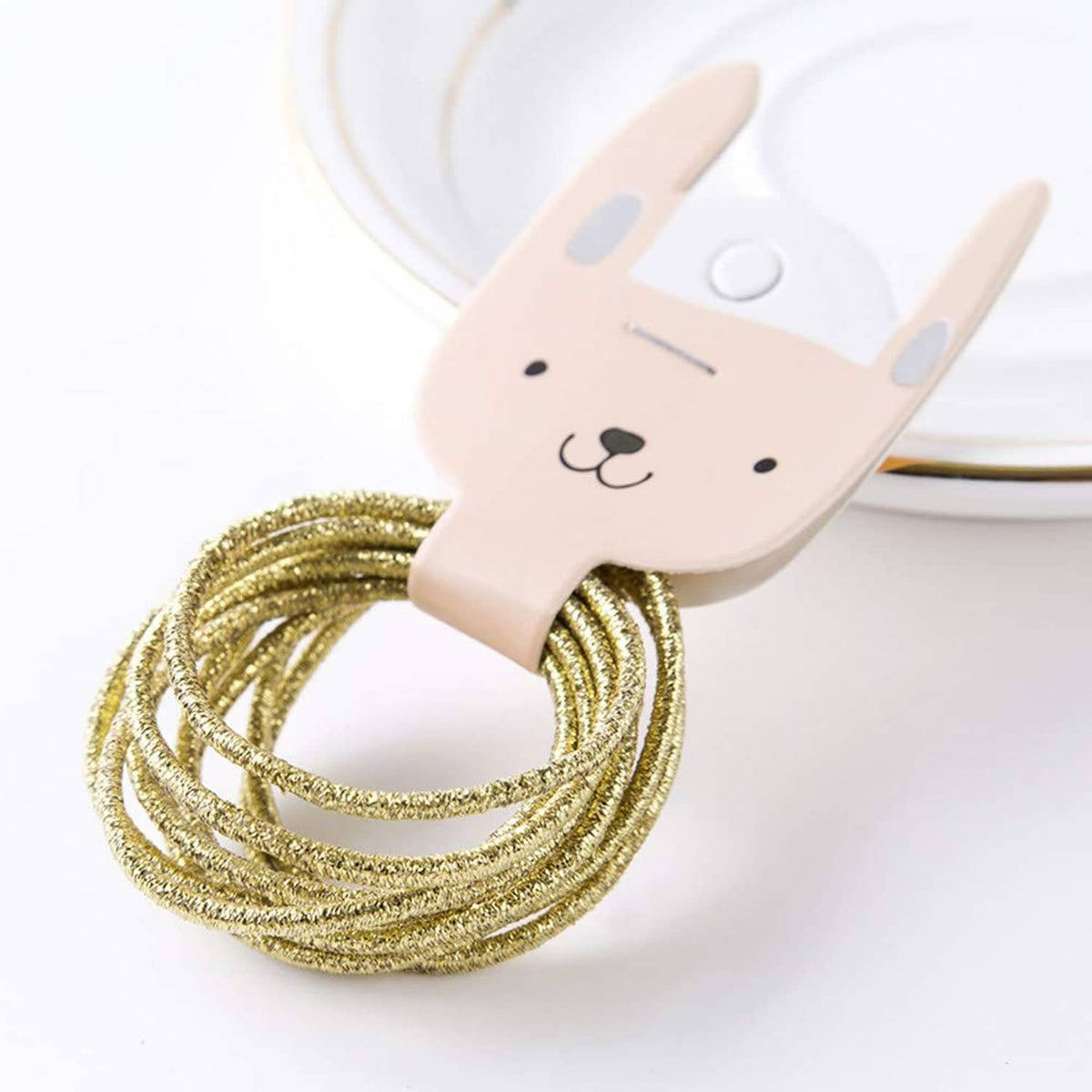 Gold glitter hair elastic loop on bunny-shaped holder