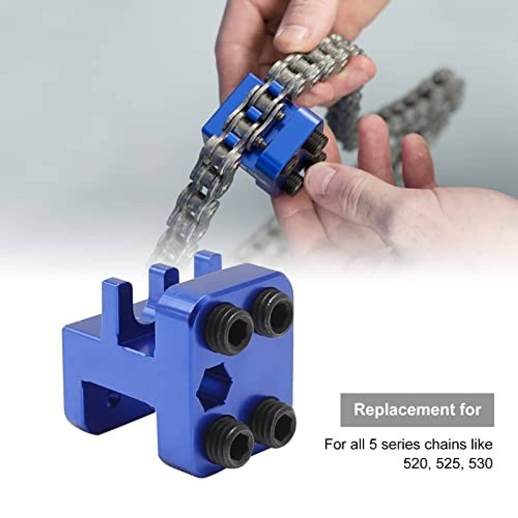 Blue chain link press tool in hand over motorcycle chain with roller posts