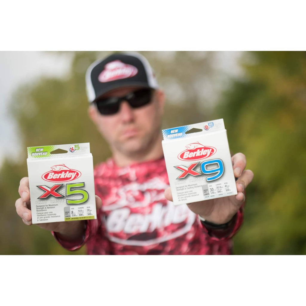 Berkley X5 and X9 braided fishing line boxes held by angler outdoors