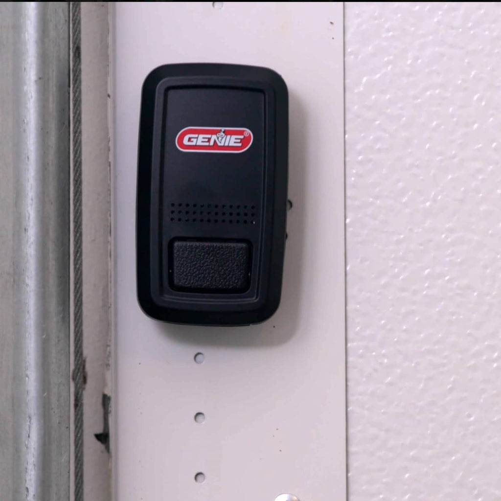 Genie door position sensor mounted on wall, black front panel