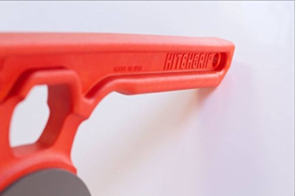 Red locking handle of a hitch ball mount carrier with molded grip