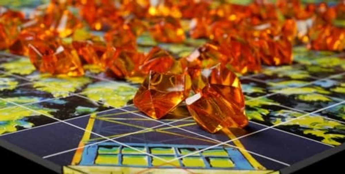 Board game play area with glowing orange fire pieces on a grid board
