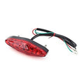 Red LED motorcycle tail light with black mount and lead wires