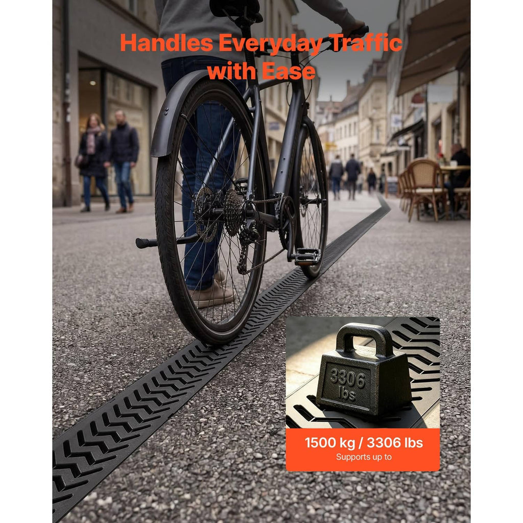 Black HDPE linear trench drain with slotted grate installed on pavement