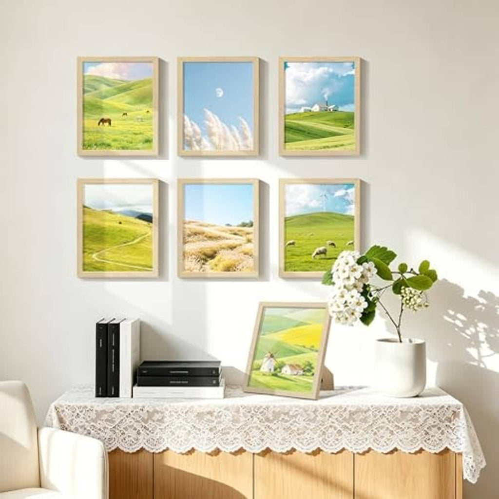 Natural wood photo frames with landscape pictures arranged for display