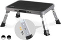 Gray and black folding step stool with textured top and four adjustable legs
