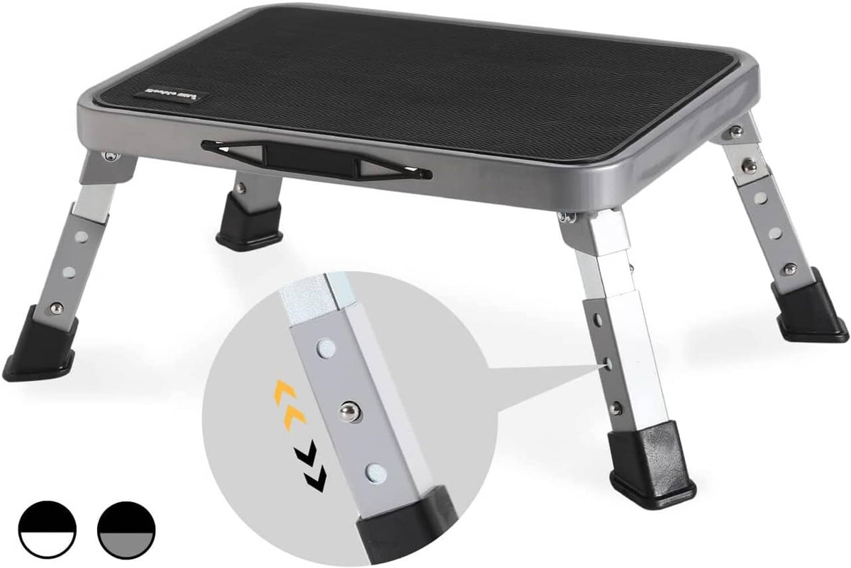 Gray and black folding step stool with textured top and four adjustable legs