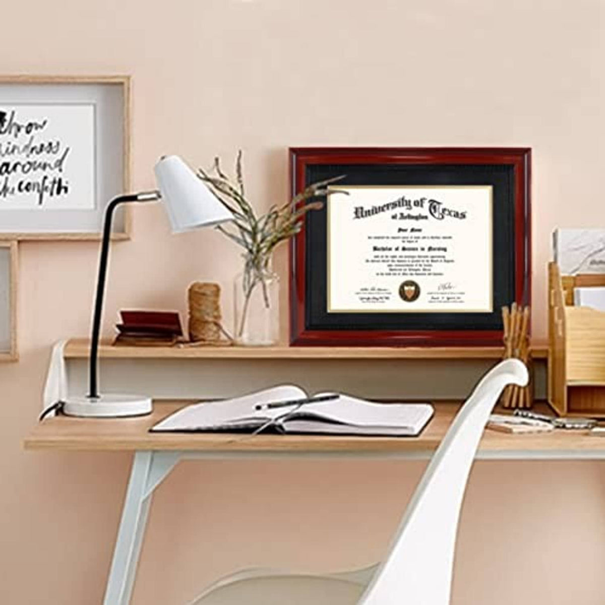 Cherry diploma frame on desk among stationery and lamp, certificate centered