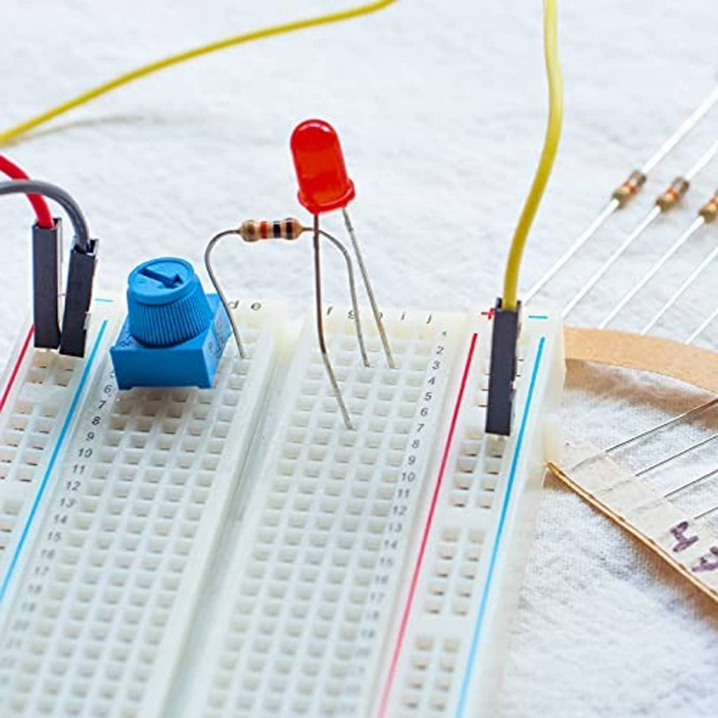 Blue potentiometer on breadboard with knob and pin leads