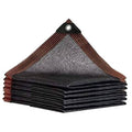 Stacked dark gray shade cloth with brown border and metal grommets