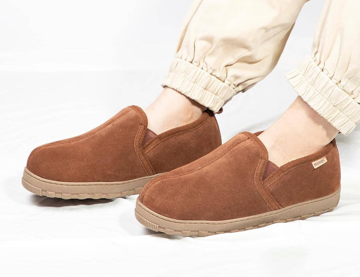Pair of men’s brown suede slip-on slippers with shearling-lined openings