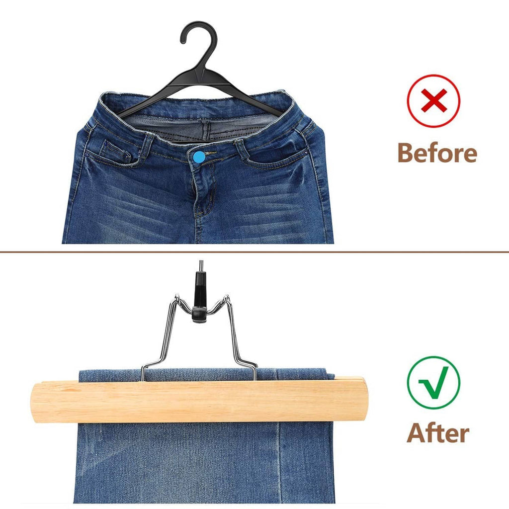 Natural wooden pants hanger with black clip holding blue jeans fabric