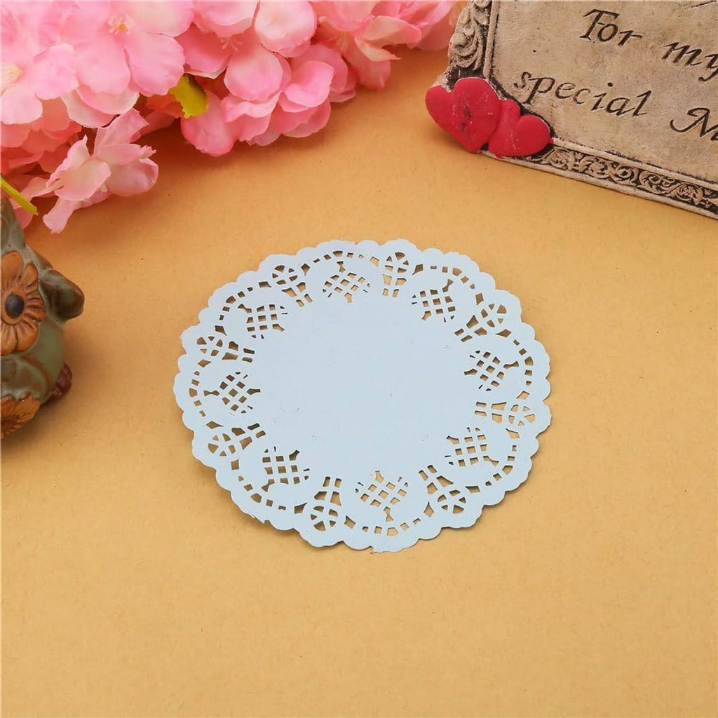 Round light blue paper lace doily, centered openwork motif and decorative border