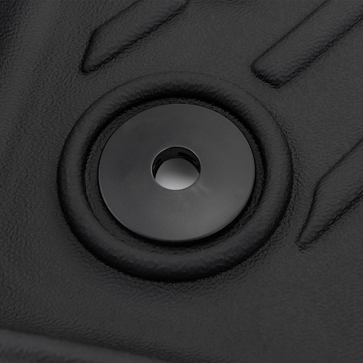 Black TPE floor mat close-up with circular grommet for secure mounting