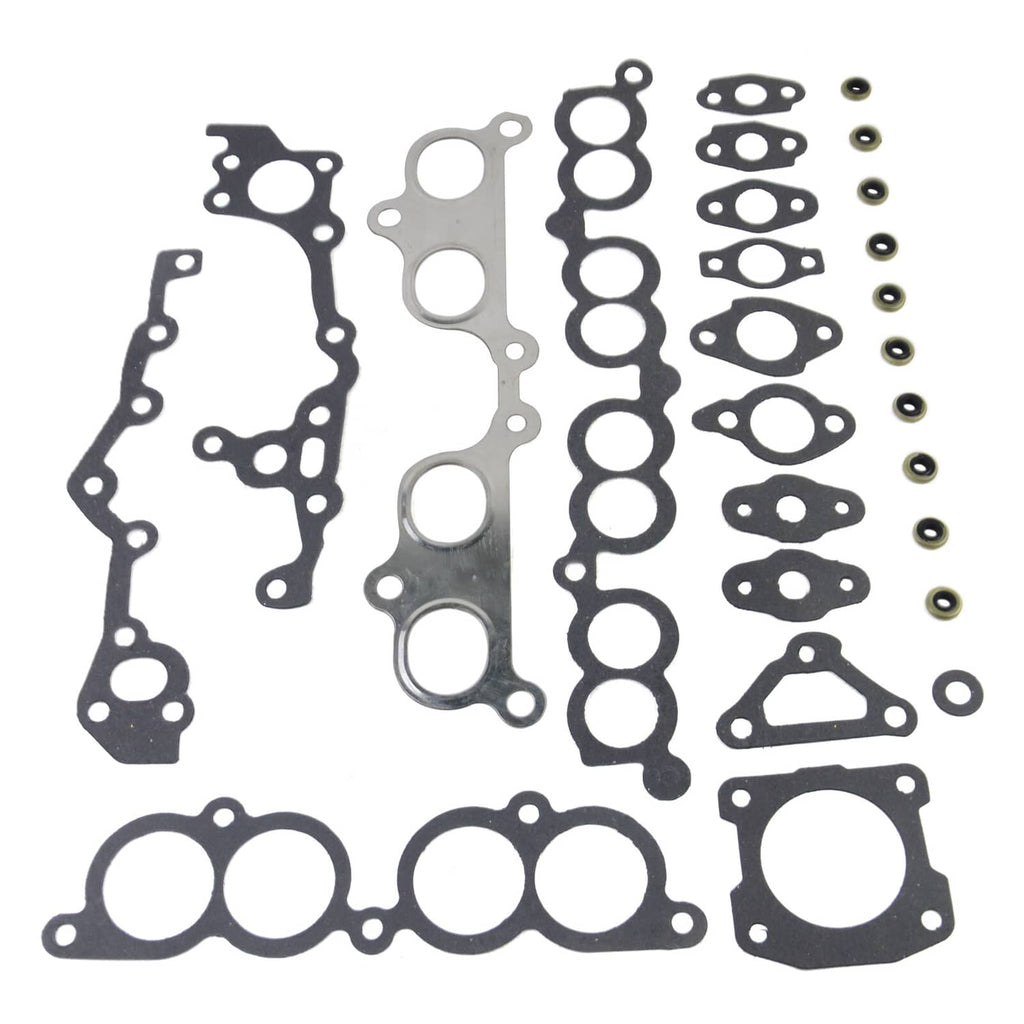 Engine head gasket set with bolts, gasket shapes and small fasteners shown on white.