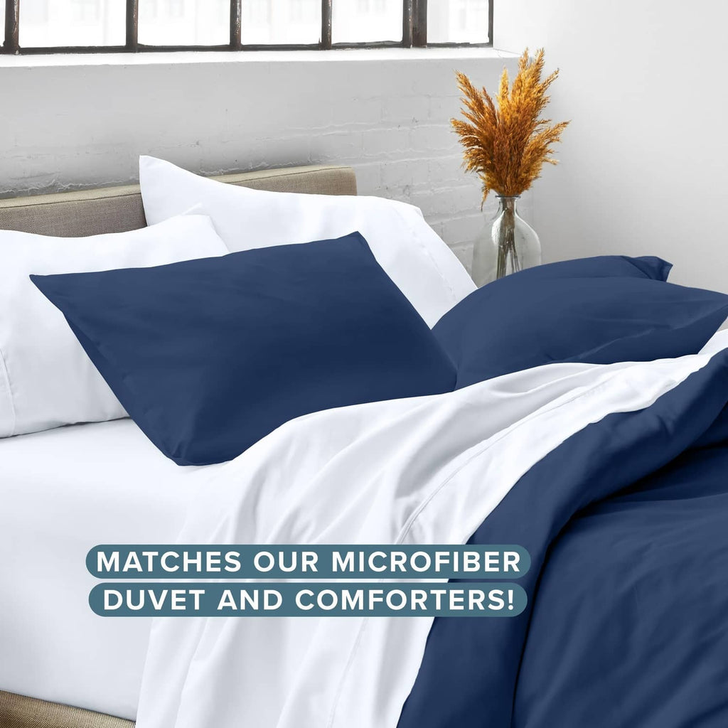 Dark blue pillow sham set on white bedding, matching microfiber look
