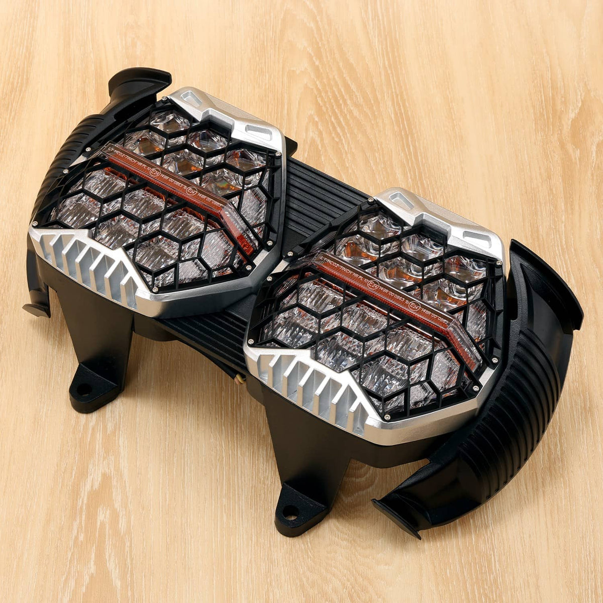 Dual LED projector headlights side angled view with silver bezels and black mounting feet