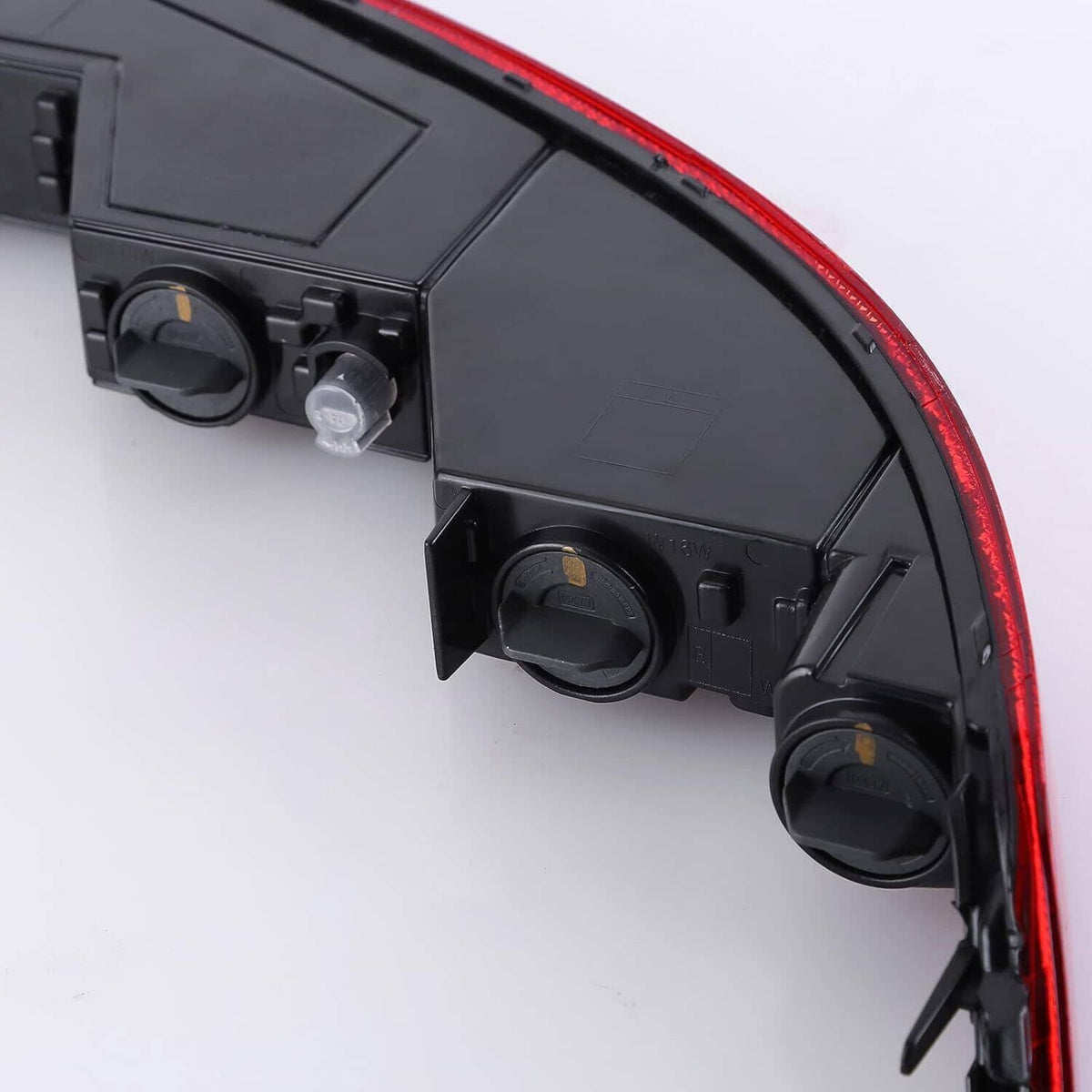 Left rear brake and fog lamp assembly with red lens and black housing, side view