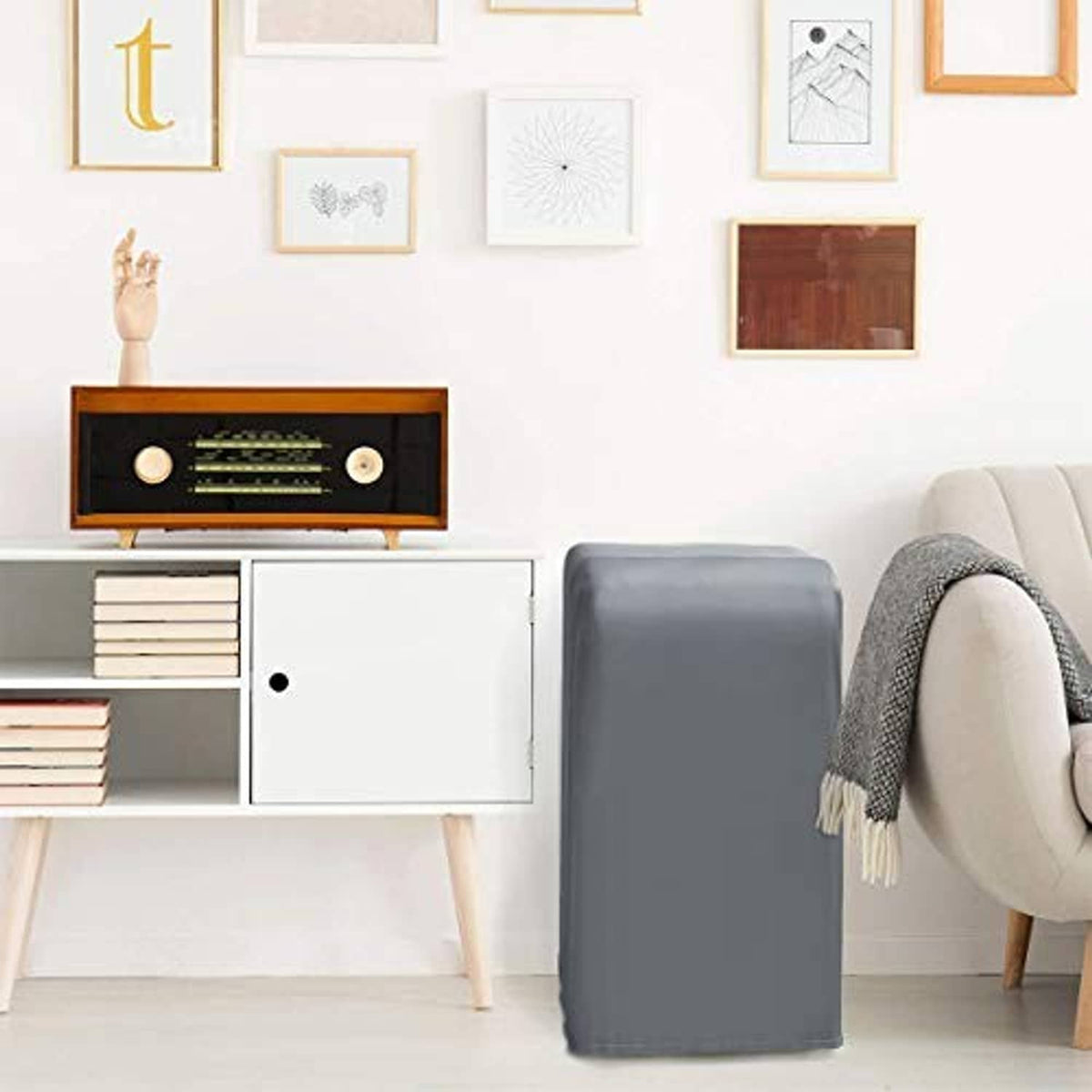 Gray portable air conditioner cover with simple front panel, placed beside furniture