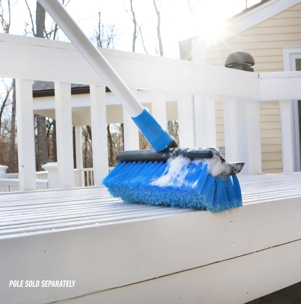 Blue soft-bristle wash brush sweeping a porch railing on an extension pole