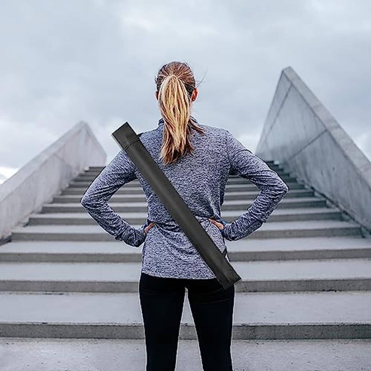 Black soft cue case carried over shoulder by a person