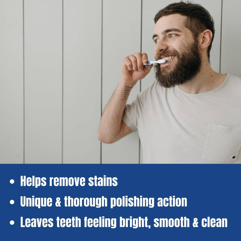 Man brushing teeth with a small scoop of toothpowder