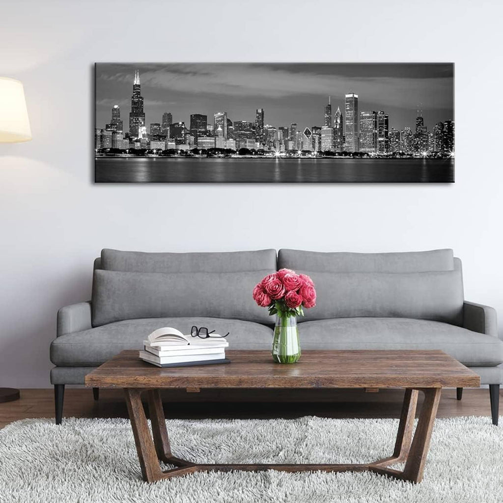 Black and white Chicago skyline canvas print centered above a gray sofa