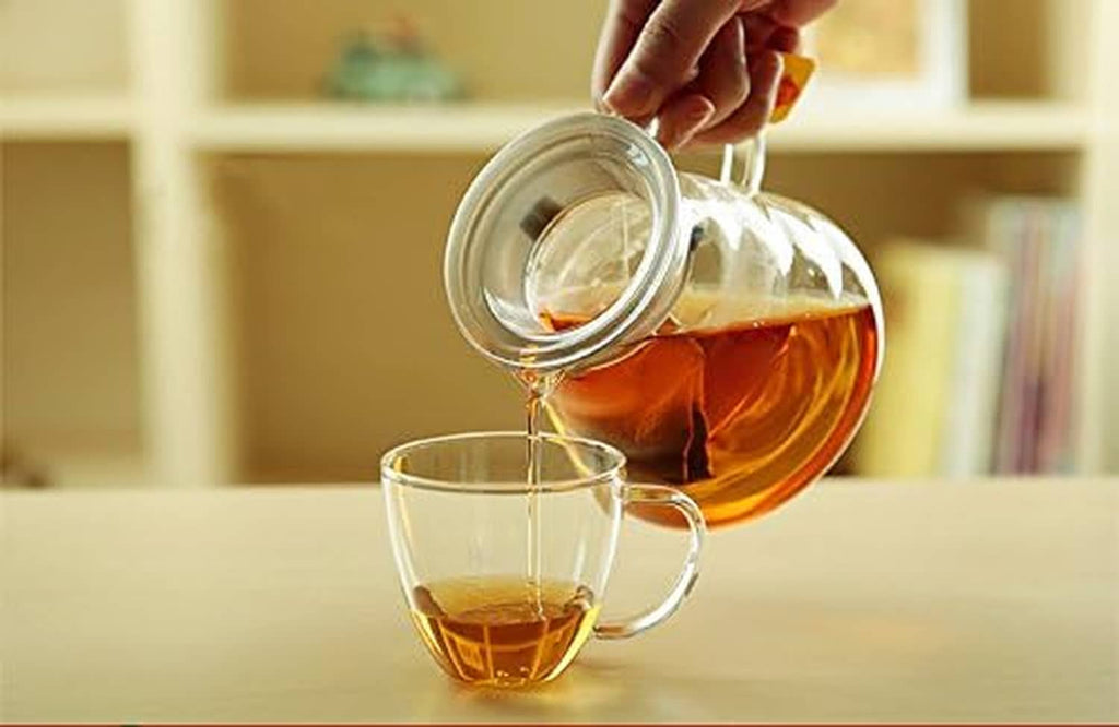 Glass coffee carafe with handle, pouring into a cup