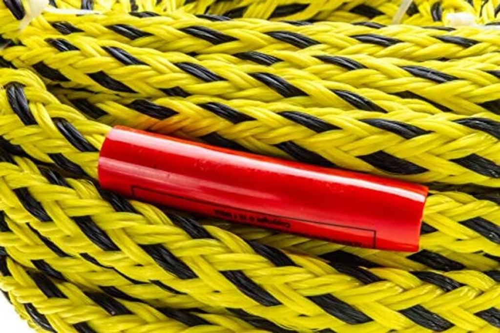 Braided yellow and black tow rope close-up with red protective sleeve