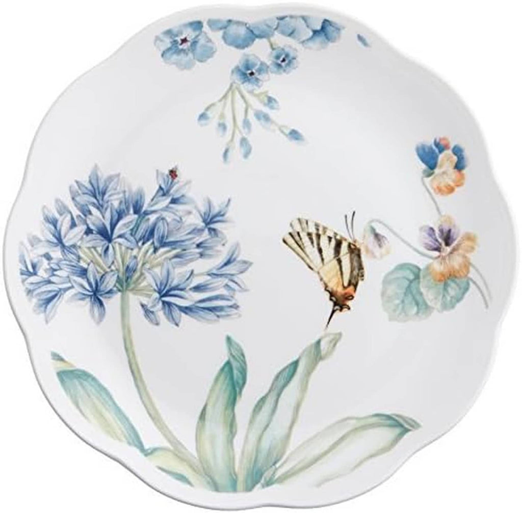 Round dessert plate with blue hydrangea-style flowers, butterflies, and green leaves on white.