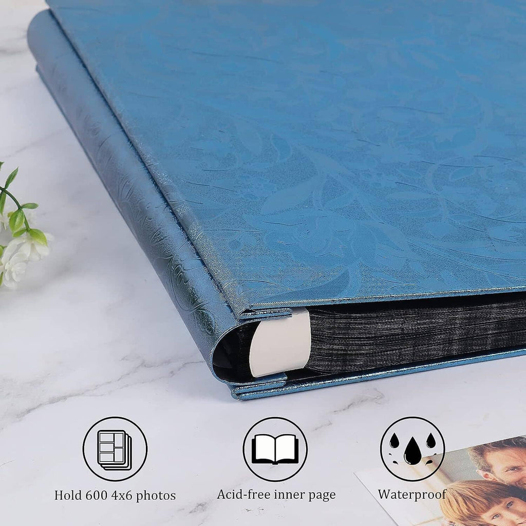 Blue photo album with leather-look cover and black spine edge, stacked angle.