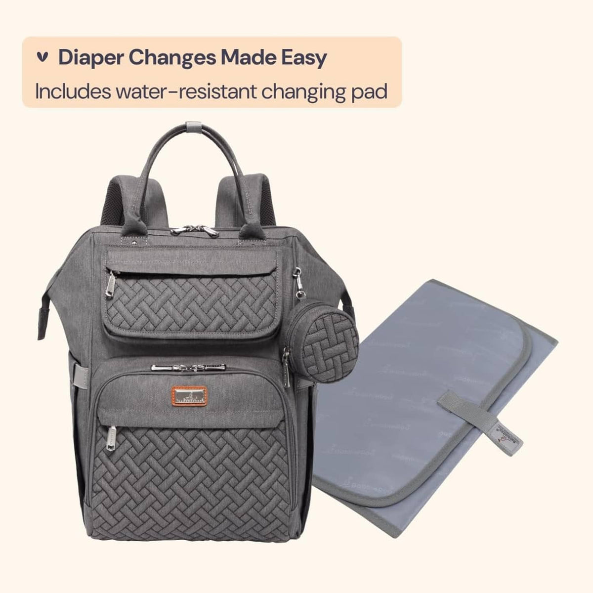 Dark gray diaper bag backpack with included water-resistant changing pad