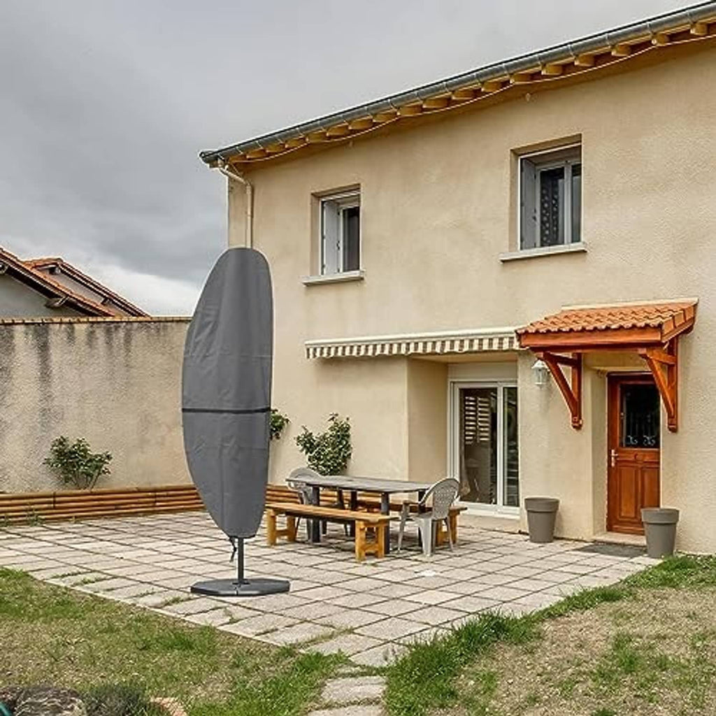 Grey cantilever umbrella cover over an outdoor patio umbrella, full-length fitted fabric