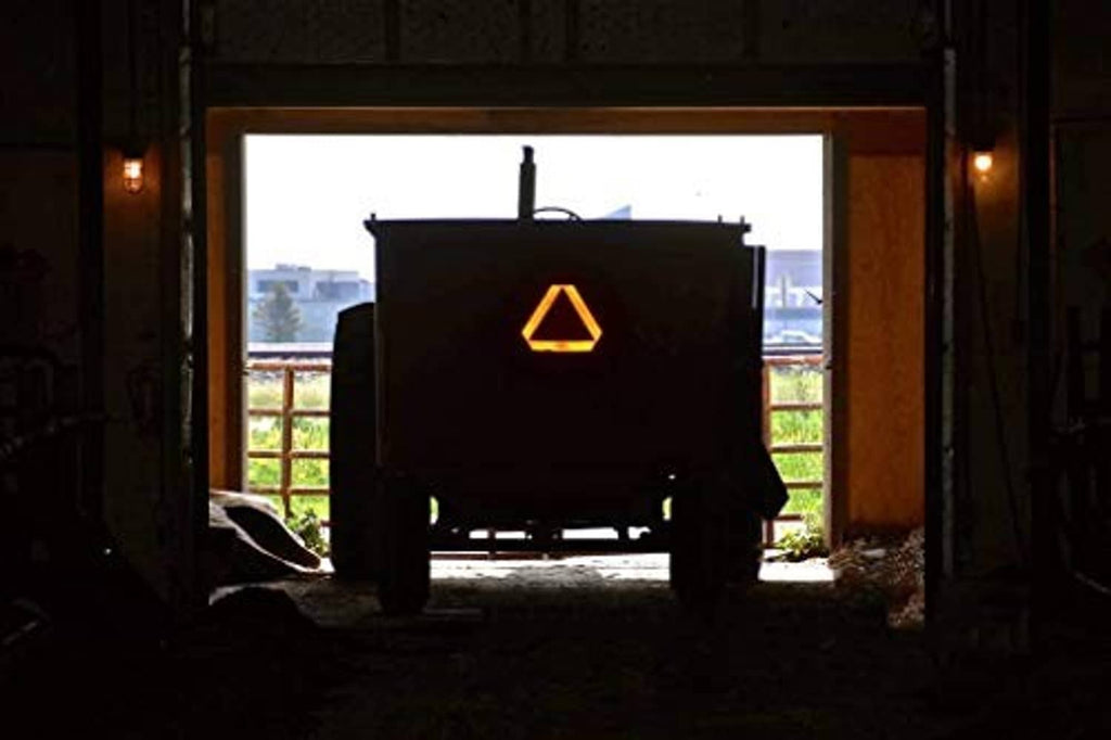 Slow moving vehicle triangle sign mounted on a vehicle at the front