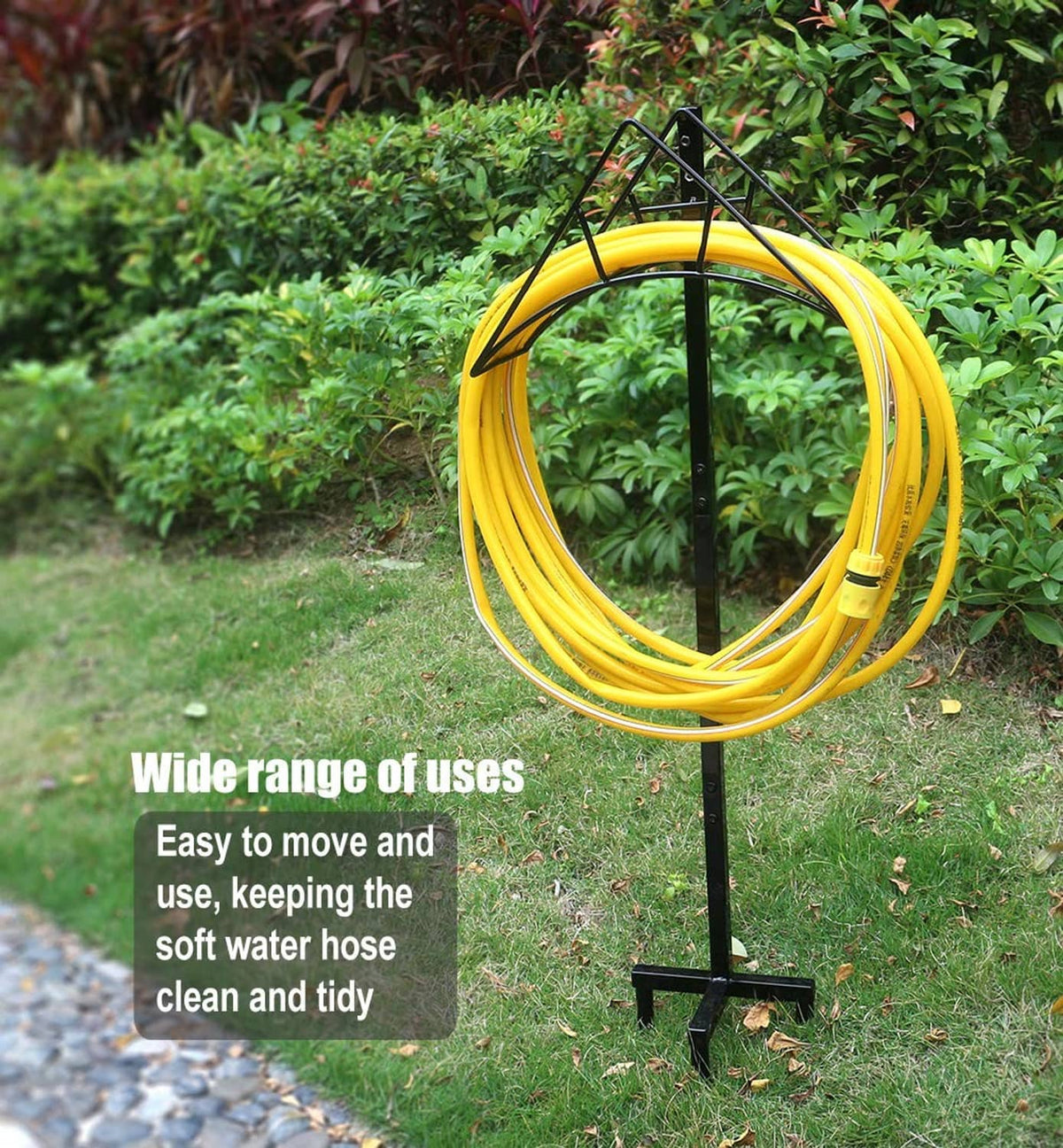 Outdoor garden hose holder stand holding a yellow hose loop on black pole